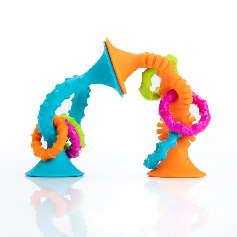 Teal and orange textured teething rings from Fat Brain called pipSquigs Loops. Has colorful rings on a white background.