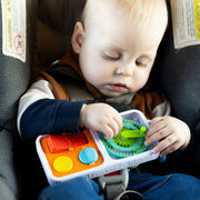 Child playing with the PlayTab Go  in a car seat.