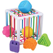 A colorful children's sensory toy cube with a white plastic frame, multicolored hanging rods, and several bright plastic shapes including a blue perforated ball, yellow ball, pink flower, orange brain, green triangle, and purple suitcase, shown on a white background.