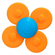 A flower-shaped baby teether or sensory toy with four bright orange petals and a blue spiral center, shown on a plain white background.