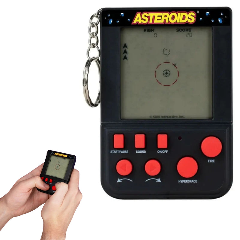 A handheld retro-style space shooter toy with a screen, red buttons, and an 'ASTEROIDS' title at the top, shown on a white background. A hand is holding a smaller version of the device in the lower left corner.