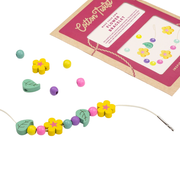 Cotton Twist bracelet-making kit with a completed flower bracelet on a white background.