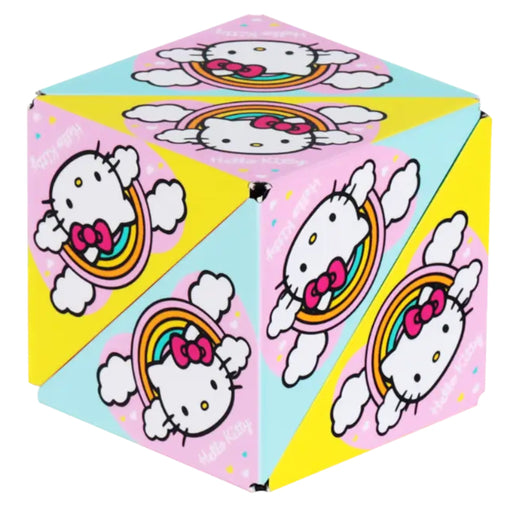A cube-shaped Hello Kitty folding box with a colorful pastel design featuring Hello Kitty, rainbows, clouds, and pink and light blue panels on a white background.
