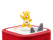 Yellow Care Bears Funshine Bear Tonie figure on red Toniebox speaker with rainbow design