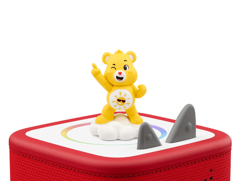 Yellow Care Bears Funshine Bear Tonie figure on red Toniebox speaker with rainbow design