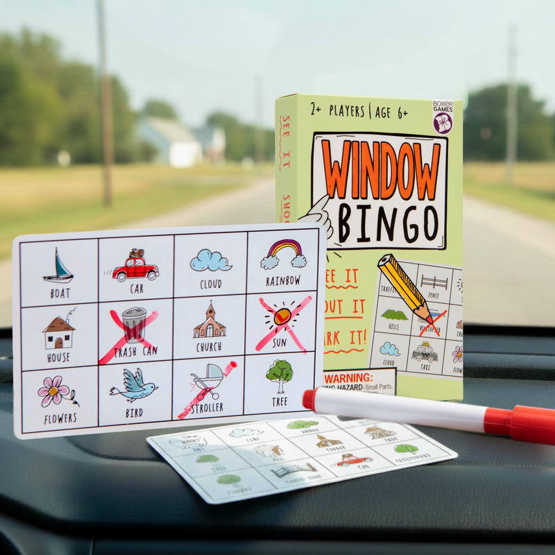 Window Bingo road trip game displayed on car dashboard with bingo cards and markers