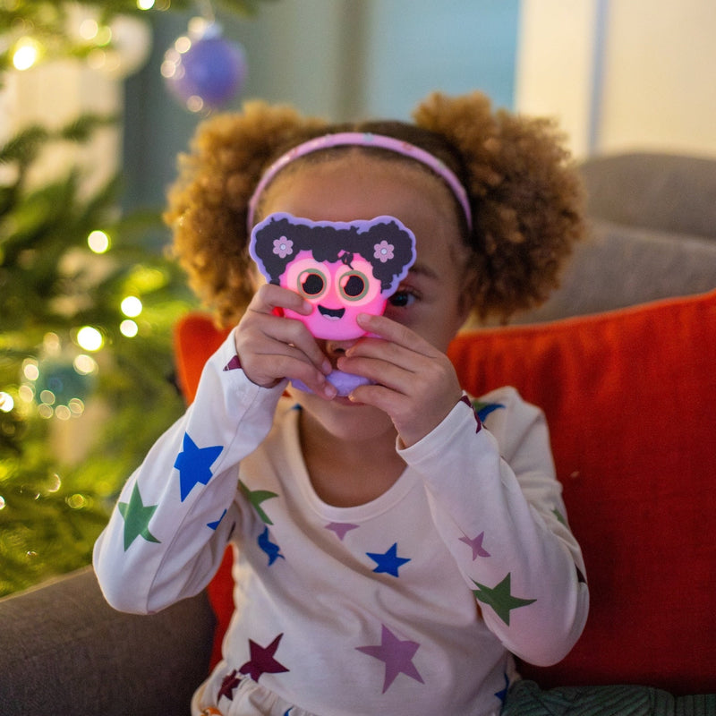 Child holding pink Glo Pals Lumi Rattle toy during Christmas playtime