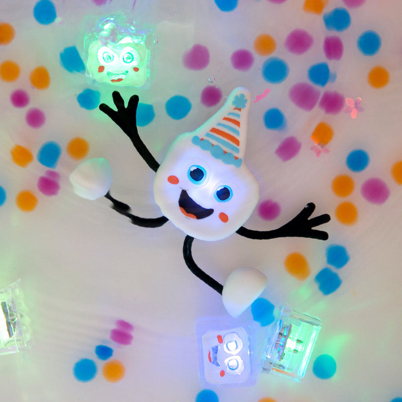 Glo Pals light-up cubes creating glowing snowman character with party hat and colorful confetti background