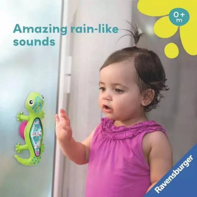 Child watching a green gecko-shaped rainmaker toy stuck on a window.
