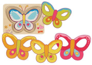 A set of colorful butterfly-shaped craft pieces and a wooden butterfly puzzle board on a plain white background. The brand name 'goki' is visible on the puzzle board.