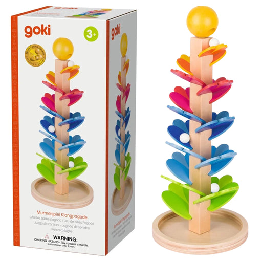 A wooden toy ball tower game by Goki, shown next to its retail packaging box. The toy features a natural light wood base and pole with colorful, flower-like spiral slides in pink, blue, green, and orange, topped with a yellow ball.