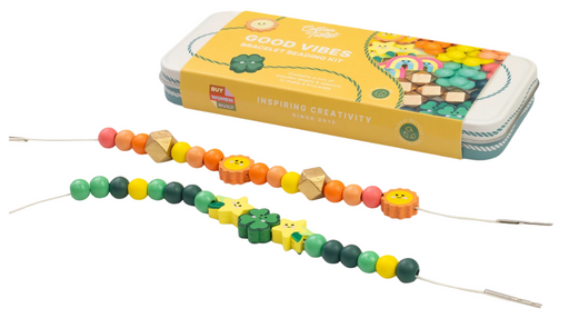 Colorful bead strings from Cotton Twist in a metal tin labeled 'Good Vibes' on a white background.