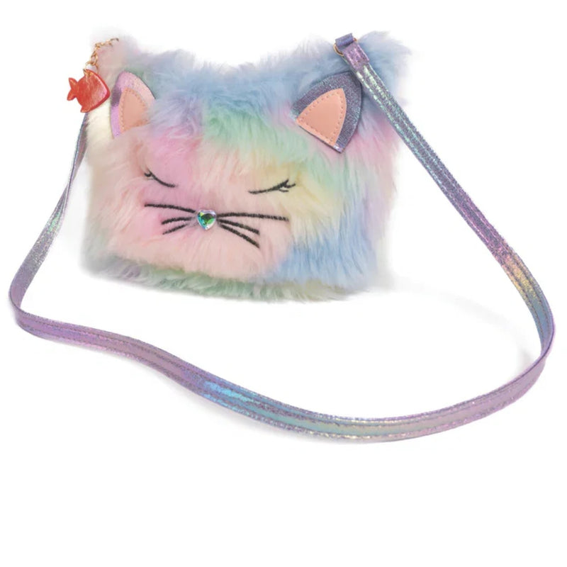 A pastel rainbow fuzzy cat-face crossbody bag with embroidered closed eyes, pink ears, a small rhinestone nose, and a shimmering iridescent strap on a white background.
