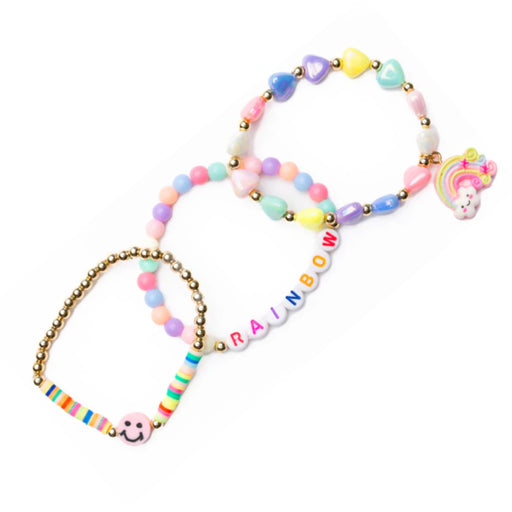 Three pastel beaded bracelets with gold-tone metal links, including a rainbow letter bracelet spelling 'RAINBOW', a unicorn charm bracelet, and a striped charm bracelet, shown on a white background.