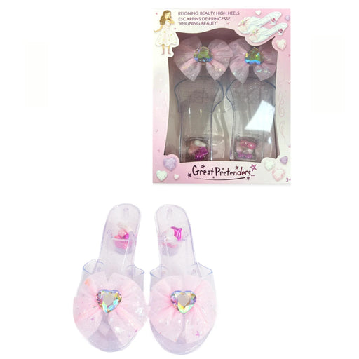 A pair of pink and clear plastic high-heeled slide sandals with large bow and heart embellishments, shown both inside their retail packaging and as a standalone product on a white background.
