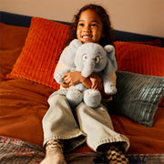 Child holding the 13.5-inch Mo Willems' Gerald plush for scale