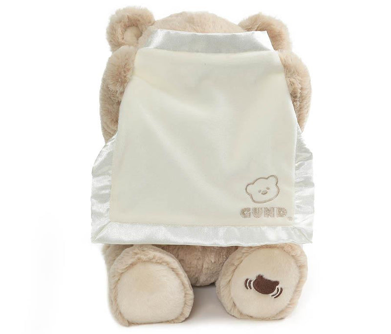 GUND Peek-A-Boo Bear plush with its cream blanket raised over its face