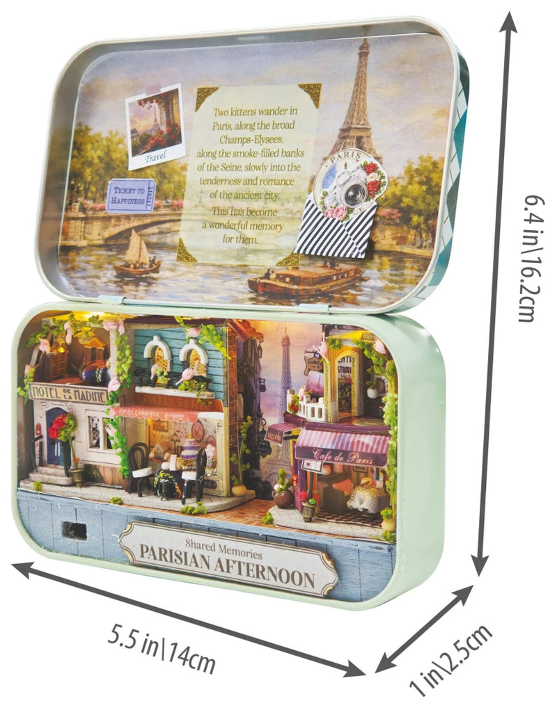 A charming Paris-inspired miniature with the Parisian Afternoon DIY Tiniature Kit on a white background. The picture also shows measurements of the finished kit of 5.5" wide and 6.4" high.  