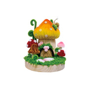 Handcrafted chenille mushroom house with colorful toadstools on wooden base