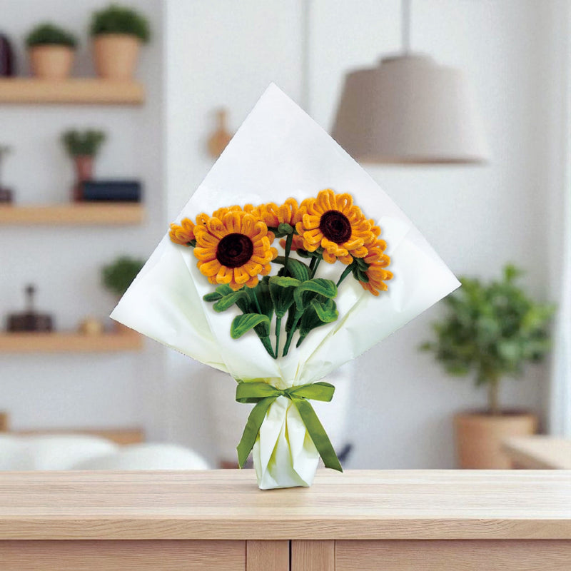 Chenille sunflower bouquet with green ribbon on wooden surface in modern room