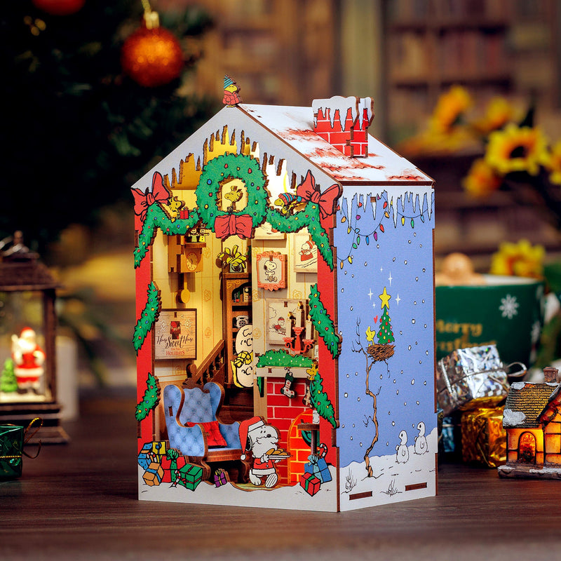 Peanuts Christmas House craft kit displayed in festive holiday setting with Christmas decorations