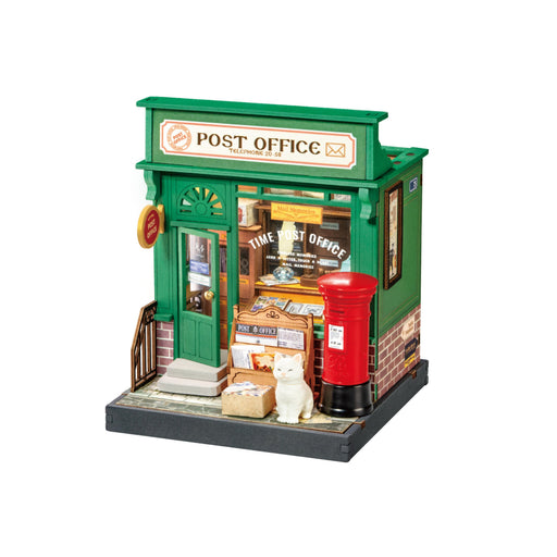 Miniature dollhouse post office building with green exterior, red mailbox, and detailed interior furnishings
