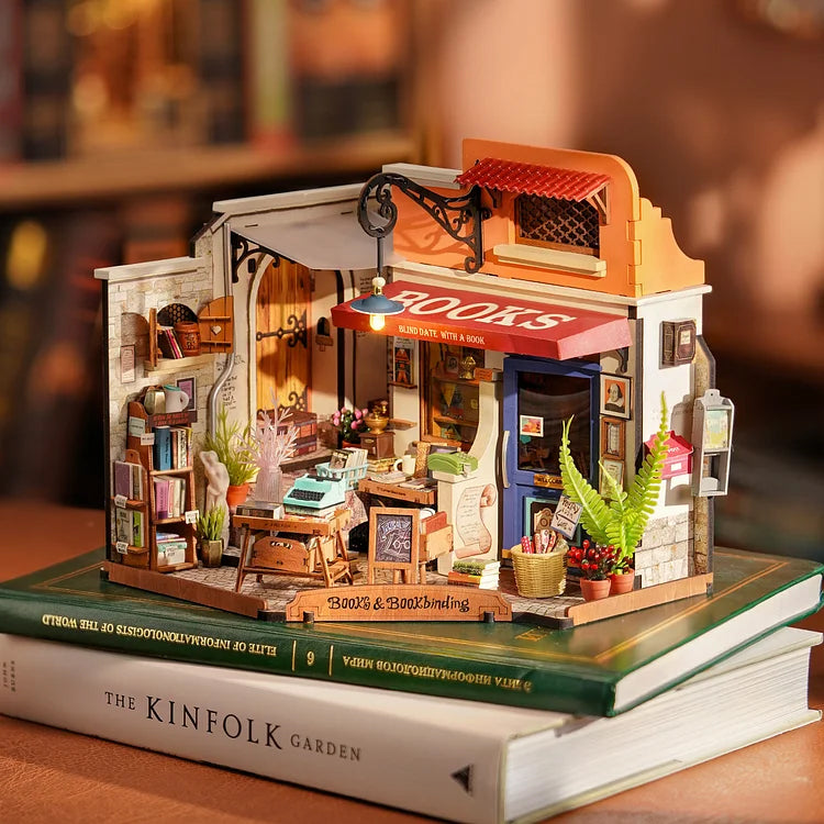 Corner Bookstore miniature dollhouse kit displayed on books in styled setting