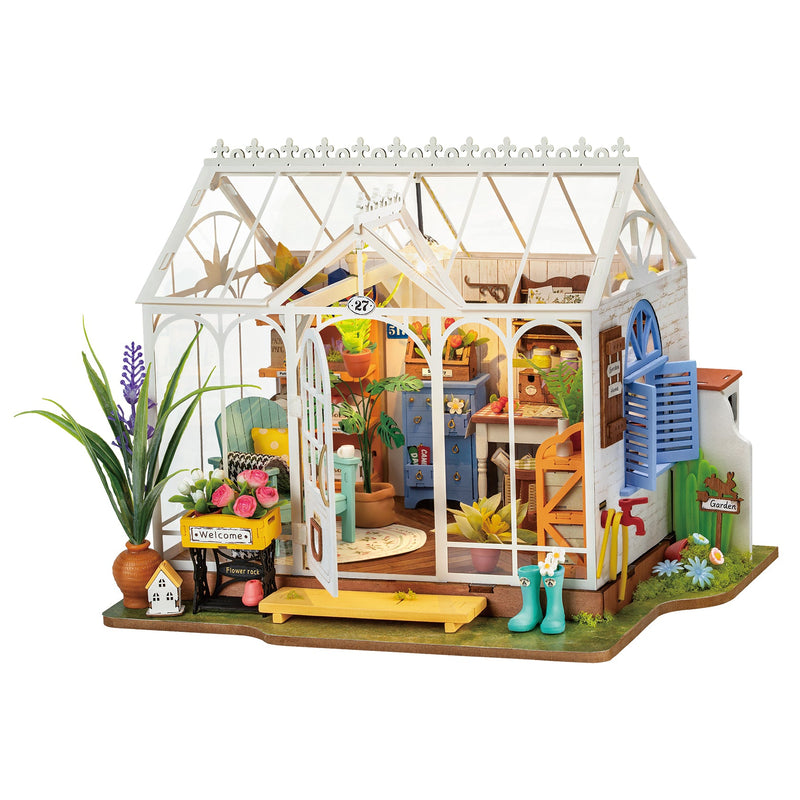 Miniature dollhouse greenhouse with detailed interior furniture and garden accessories