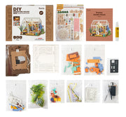 DIY miniature dollhouse kit with packaging, parts, and assembly components displayed