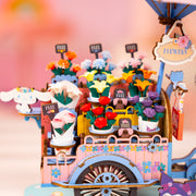 Colorful miniature flower cart diorama with bouquets and FREE signs in whimsical setting