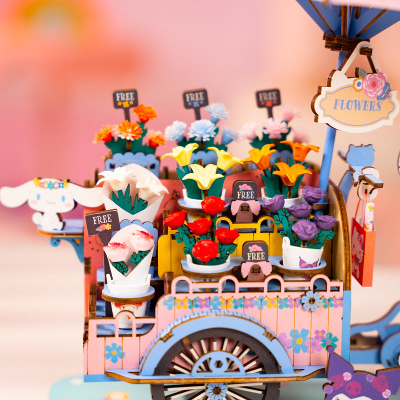 Colorful miniature flower cart diorama with bouquets and FREE signs in whimsical setting