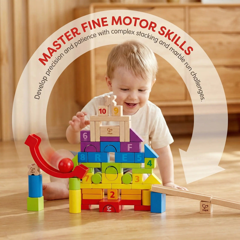 Toddler smiling while stacking colorful Hape wooden number blocks with marble run