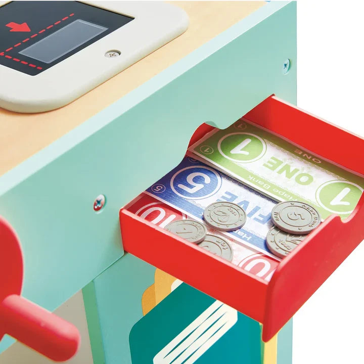 Close-up of wooden supermarket toy cash drawer with play money bills and coins