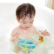 Toddler playing with Hape pull-back boat and bear floatie toy in bathtub