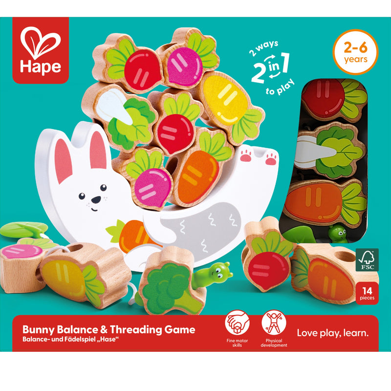 Hape Bunny Balance & Threading Game wooden toy set on a teal background, showing colorful carrot and vegetable pieces, a white bunny figure, packaging window view, and age 2-6 years text.