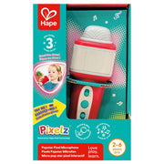 Hape Pixelz Popstar Pixel Microphone toy in its original retail packaging, featuring a red and white pixelated microphone with a turquoise handle inside a teal and red box.