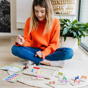 Girl playing with Horse Academy stable set on the floor