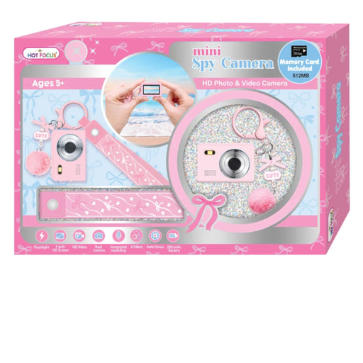 Hot Focusup Mini Spy Camera toy set in its original pink retail packaging, featuring a pink toy camera, matching strap, keychain, and glittery round accessory inside a decorated box.