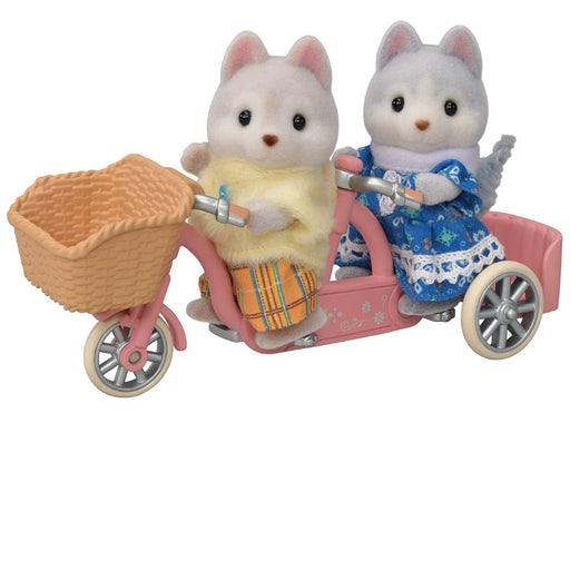 Calico Critterd Huskie Dog twins riding a pink bike with a basket on a white background.