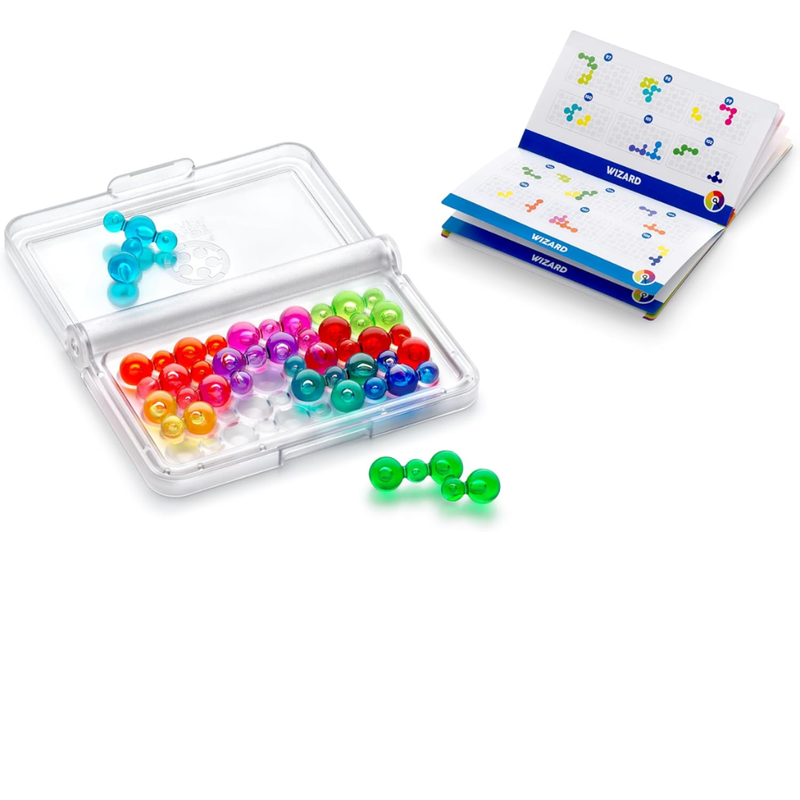 Colorful magnetic beads in a clear plastic case with a book of puzzle challenges on a white background.