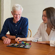 Man and woman playing IQ Penta together at a table.