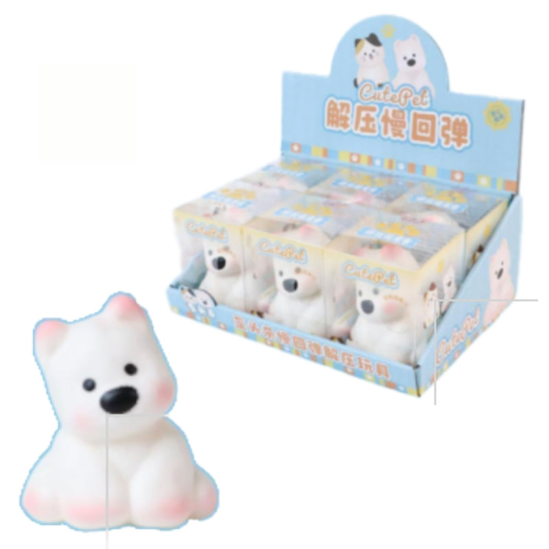 A retail display box filled with small packaged white dog squishy toys, with one loose white dog placed in front on a plain white background. The packaging has pastel blue, yellow, and pink accents with cartoon bear illustrations and Chinese text.