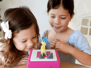 Two children playing with Joy Tonie figure from Disney Inside Out on Toniebox