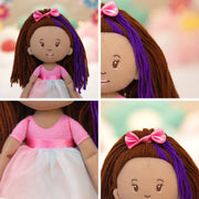 Groovy Girls Iris plush doll with brown and purple yarn hair, pink bow, and pink tulle dress.