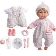 Baby doll and outfit set with a pink and white floral romper, matching hat, pacifier clip, white bib, pink shoes, pacifier, bottle, bowl, spoon, and knife, shown on a white background.