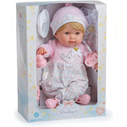 A baby doll in a pink outfit and matching hat, displayed inside its retail packaging box. The doll has blonde hair and blue eyes, and the box features pastel blue and white designs with yellow stars.
