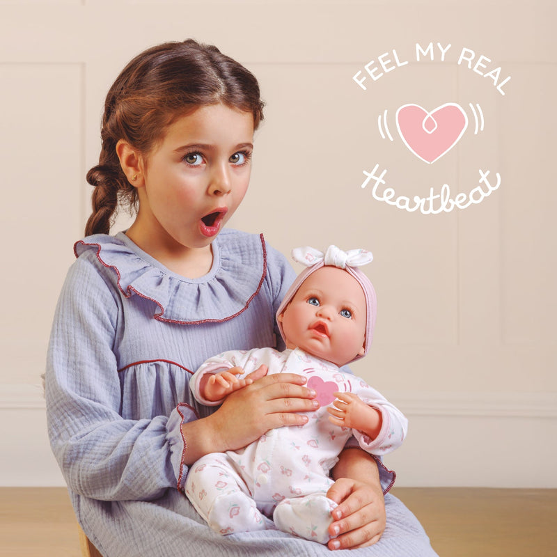 Child holding the Bonbebé doll and pressing the heart area to feel the heartbeat feature.