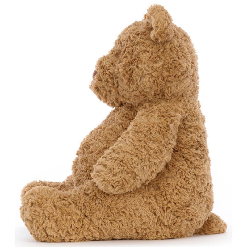 Left side view of classic Teddy Bear Bartholomew from Jellycat.  Light brown color, soft plush fur on white background.