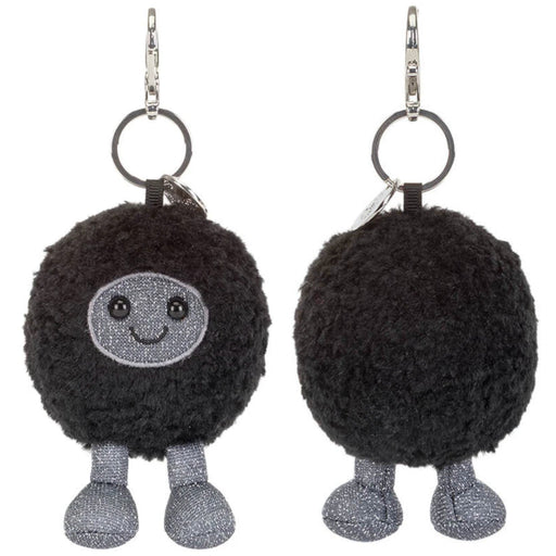 Two views of the black hole keychain charm with a silver glittery face and legs, shown on a plain white background.