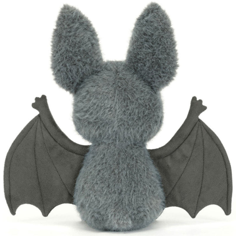 The backside of a plush toy bat with soft gray fur, large upright ears, dark wings spread wide, and a small pink nose on a plain white background.